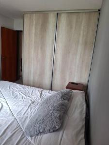 a white bed with a pillow on top of it at Casa para 4 personas Epoca Festival Doma y Folcklore in Jesús María +3 photos