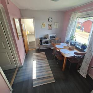a room with a table and chairs and a kitchen at Lägenhet i Hestra in Hestra