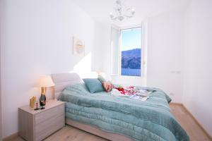 Postel nebo postele na pokoji v ubytování Villa Larius Balcone