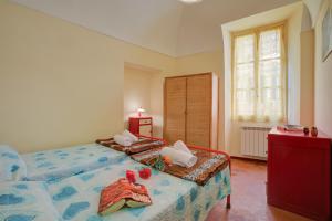 a bedroom with two beds and a dresser at Ca Moretto - Happy Rentals in Sanremo