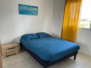 Ένα ή περισσότερα κρεβάτια σε δωμάτιο στο Résidence les villas bleues