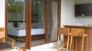 a room with a bed and a table and chairs at Mahanadewi Villa in Ubud