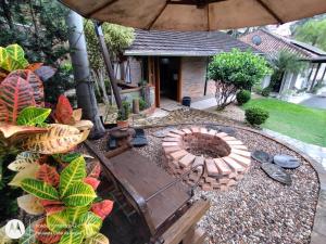 a backyard with a fire pit and an umbrella at Casa da Lagoa - Gasthaus Pomerode in Pomerode
