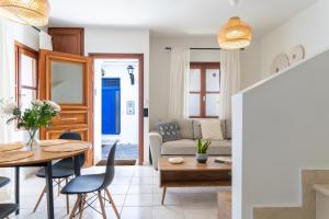 a living room with a table and a couch at Olea White in Skiathos