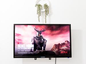a television screen with a picture of a reindeer at Charming Private Studio-EnSuite & Kitchenette in Town centre Apartment in Lillington +7 photos