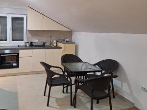 a kitchen with four chairs and a table in it at Apartman Kolašin in Kolašin