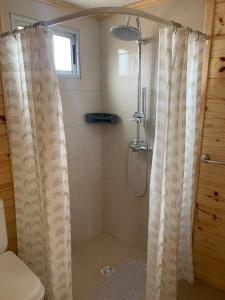 a shower with a shower curtain in a bathroom at Laslu in Punta Del Diablo +22 photos
