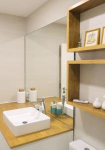 a bathroom with a white sink and a mirror at Beachfront apartment T2 Costa Nova Surf Aveiro in Gafanha da Encarnação +24 photos