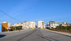 an empty street in a city with buildings at Beachfront apartment T2 Costa Nova Surf Aveiro in Gafanha da Encarnação