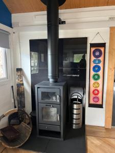 a fireplace in a room with a stove in it at Semi Off Grid Fearless Fox Lodge complete with Log burners, Hot Tub & Sauna in Altham