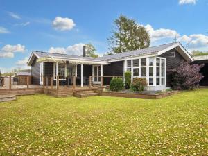 a house with a lawn in front of it at 5 person holiday home in Fårvang-By Traum in Fårvang