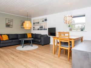 a living room with a couch and a table at 5 person holiday home in Fårvang-By Traum in Fårvang +21 photos