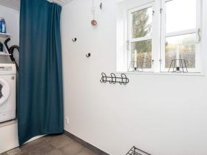a kitchen with a green curtain and a window at 5 person holiday home in Fårvang-By Traum in Fårvang