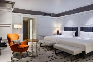 a hotel room with a large bed and a chair at London Marriott Hotel County Hall in London