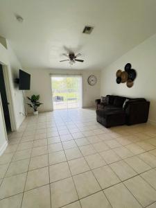a living room with a couch and a ceiling fan at Spacious Home at Lehigh Acres in Lehigh Acres