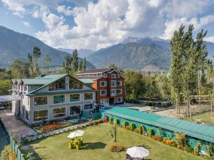 an aerial view of a resort with mountains in the background at Hotel River View Resort in Pahalgām
