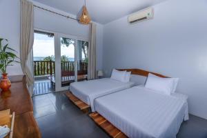 Postel nebo postele na pokoji v ubytování Cosian Bay Phu Quoc Resort + 37 fotografií
