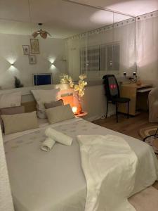 a bedroom with a large white bed and a desk at Appartement Relaxe in Carquefou