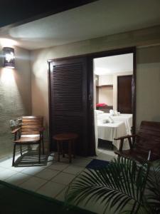 a room with two chairs and a table with a bed at Hotel Pousada Cumbuco Gold in Cumbuco +34 photos