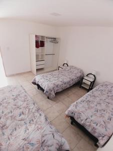 a bedroom with two beds and an oven in it at Rincón Patagónico in Esquel