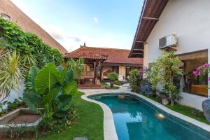 a swimming pool in the yard of a house at Villa Chantal-Intimate Villa in Seminyak in Seminyak
