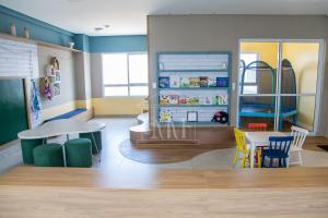 a toy store with a table and a refrigerator at Studio Completo a Beira Mar, Grand Smart Residence in Aracaju
