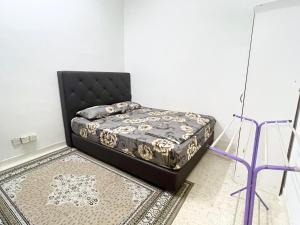 a bed sitting in a corner of a room at CikSiti homestay02 in Kajang