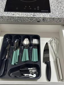 a kitchen counter with a sink with utensils at Apto premium próximo Allianz Parque e Espaço Unimed in Sao Paulo +9 photos
