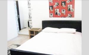 a bedroom with a white bed and a red wall at Piața Sfatului House in Braşov