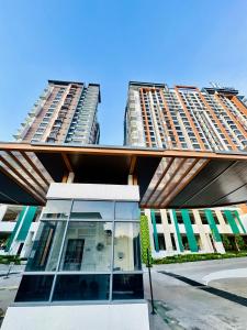 a building with two tall buildings in the background at Fayyadh homestay K Avenue in Kota Kinabalu +23 photos