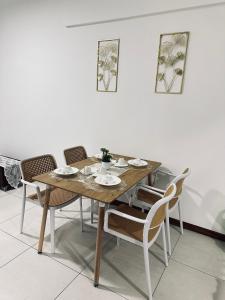 a dining room table with chairs and a wooden table at Fayyadh homestay K Avenue in Kota Kinabalu