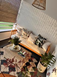 a living room with a couch and a table at Sunny Brae Manor in Great Brak River +23 photos