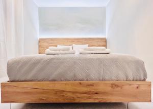 a bed with two pillows on top of it at ITHACA Άνετο διαμέρισμα 3ου με θέα in Thessaloniki