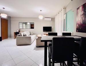 a living room with a couch and a table at ITHACA Άνετο διαμέρισμα 3ου με θέα in Thessaloniki