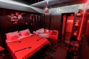 a red room with a bed and a mirror at Romeo Nights - Private Rooms - Adults Only in Bucharest +74 photos
