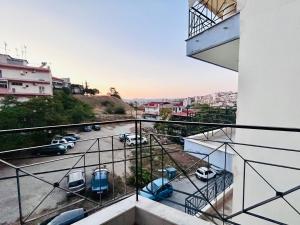 a balcony with cars parked in a parking lot at ITHACA Άνετο διαμέρισμα 3ου με θέα in Thessaloniki
