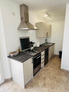 a kitchen with a stove and a sink at Renbeck lets 1 in Urcal