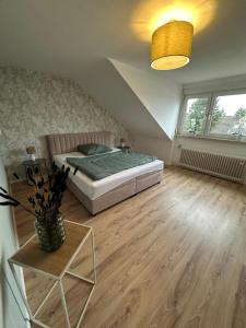 a bedroom with a bed and a table and a window at Ferienhaus Pirmasens in Pirmasens