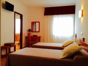 Posteľ alebo postele v izbe v ubytovaní Hostal Eden