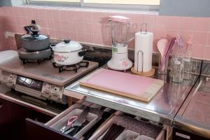 a kitchen counter with a stove with a blender at Benton Guesthouse, Private Nostalgic Showa-era House, former "Akiya" in Imabari