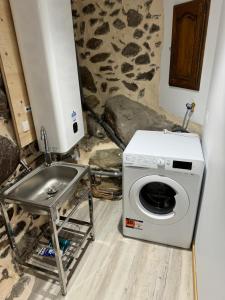 a washing machine and a sink in a room at Gîte pied du mont fourcat in Mercus-Garrabet +3 photos