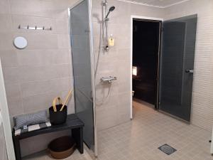 a shower with a glass door in a bathroom at Holiday Home Joutsen in Parikkala +20 photos
