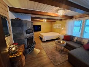 a living room with a couch and a bed at Holiday Home Joutsen in Parikkala