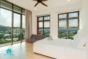a bedroom with a white bed and large windows at D'Moon Escapes Ampang KL 4BR in Kampong Ulu Kelang +25 photos