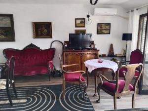 a living room with a couch and a table and chairs at Apartments Colic in Herceg-Novi