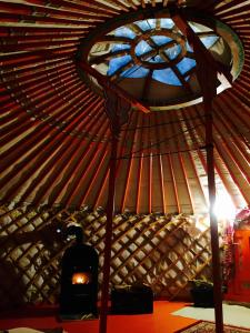 a room with a yurt with a window and a candle at Dobogókő Jurtaszállás in Dobogoko