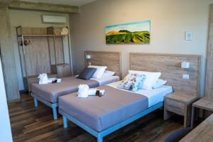 two beds in a hotel room with two tables at Masseria Spinale Wine Resort in Melfi +89 photos