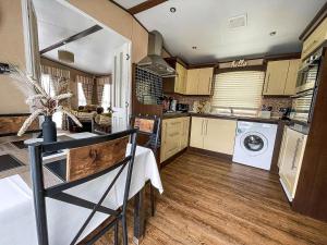 a large kitchen with a washer and dryer in it at Beautiful Caravan At Manor Park In Hunstanton Beach, Norfolk Ref 23026H in Hunstanton