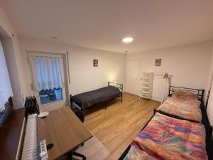 a room with two beds and a table in it at Big, cosy and central apartment in Karlsruhe +7 photos