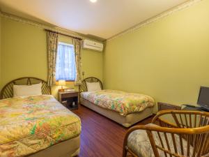 Ένα ή περισσότερα κρεβάτια σε δωμάτιο στο Petit Resort Hotel Alcyon